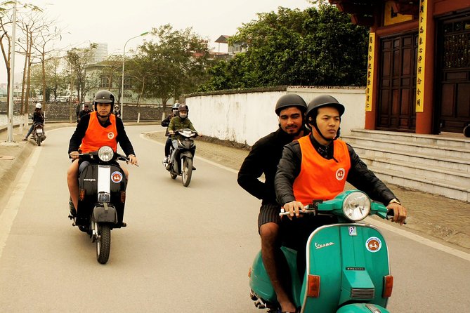 HANOI MUST SEE SITES Vespa Tour - Long Bien Bridge: crossing the Red River and spotting the Guinness mosaic wall
